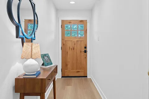 a living room with furniture a fireplace and a chandelier