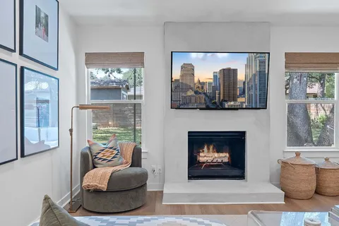 a living room with furniture and a dining table with kitchen view