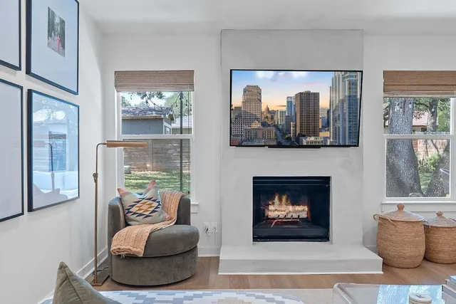 a living room with furniture and a dining table with kitchen view