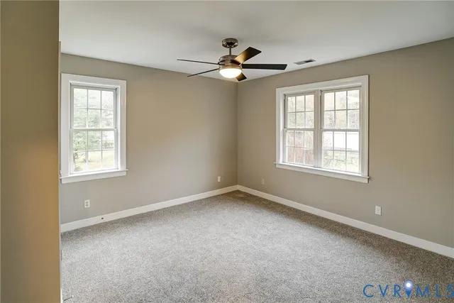 a view of room with a ceiling fan and window