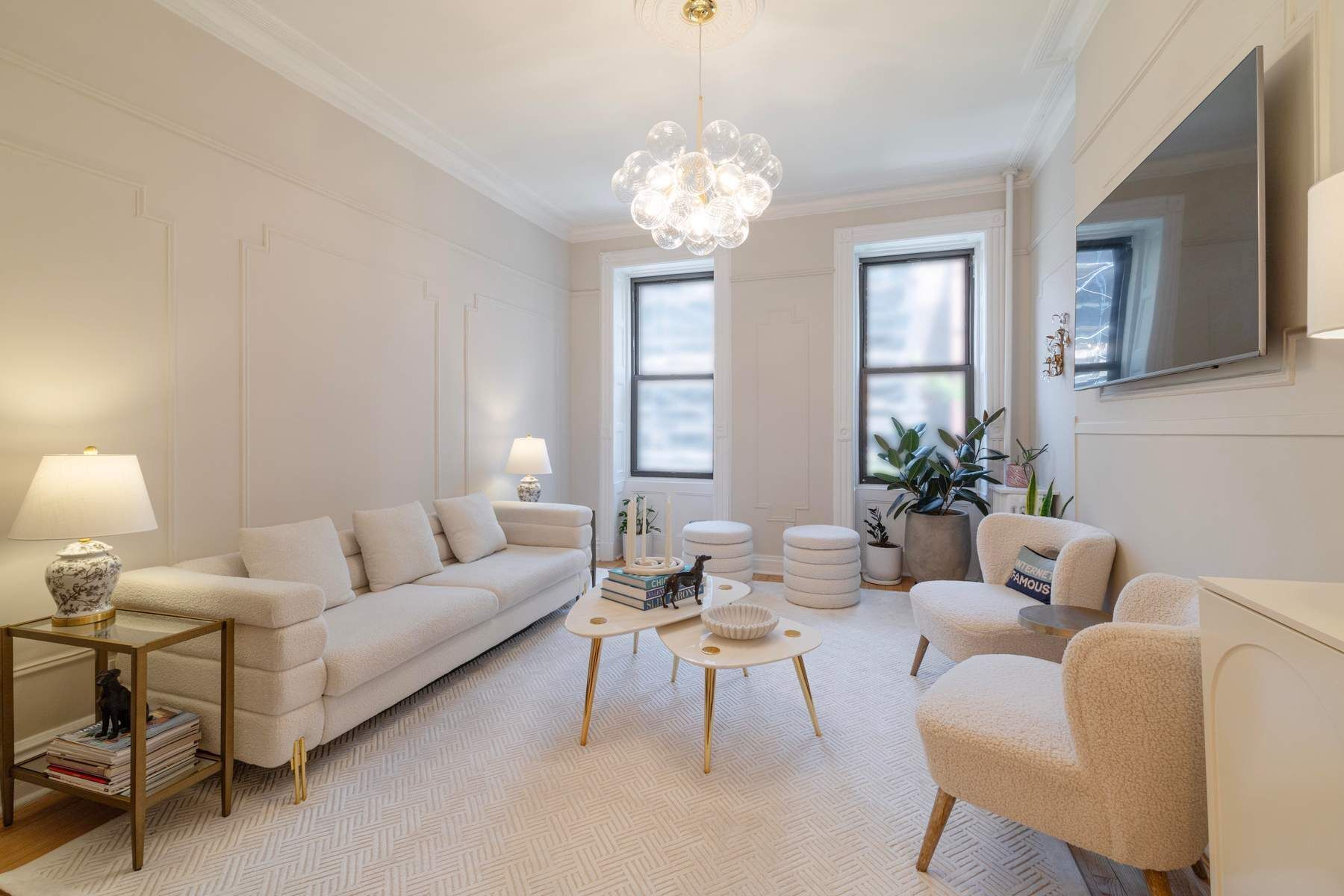 350 West 48th Street, Unit 4E Manhattan, NY 10036 - Photo 1 of 12 a living room with furniture a chandelier and a window