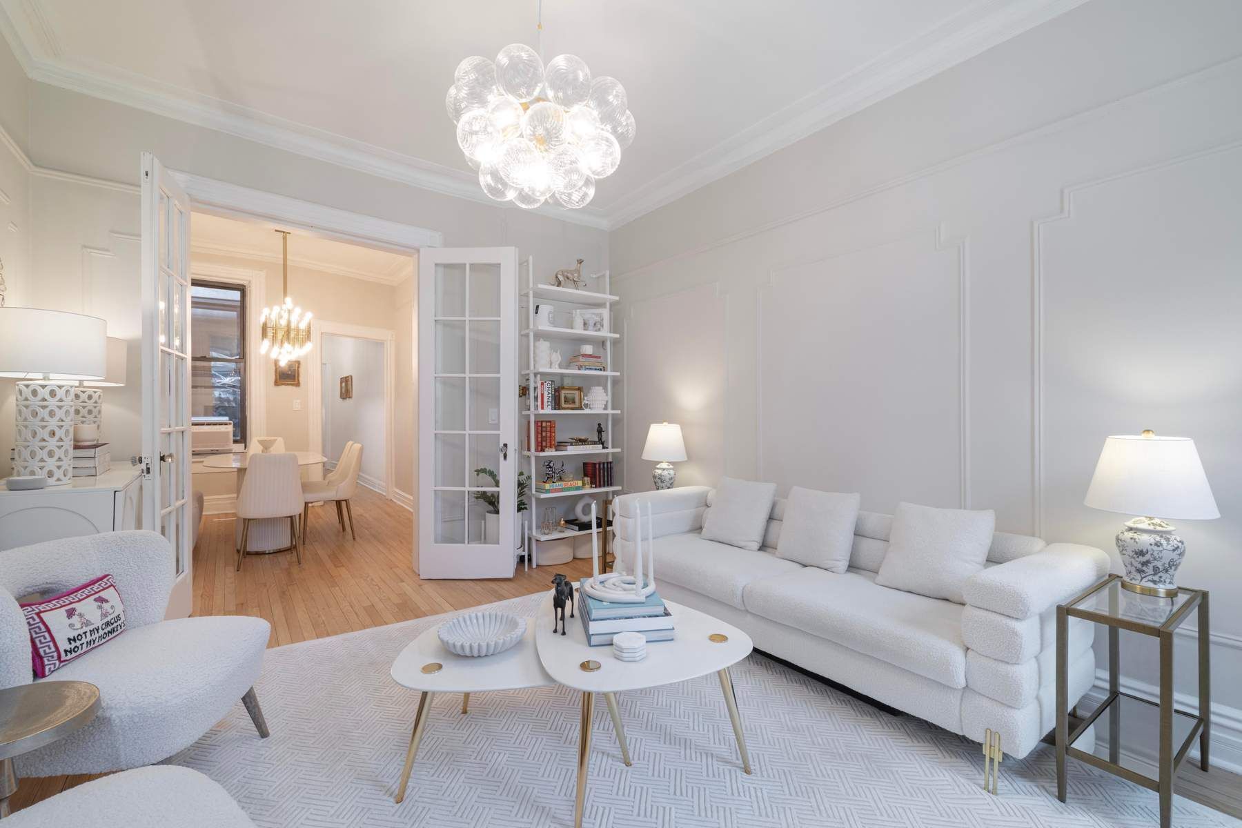350 West 48th Street, Unit 4E Manhattan, NY 10036 - Photo 2 of 12 a living room with furniture and a chandelier