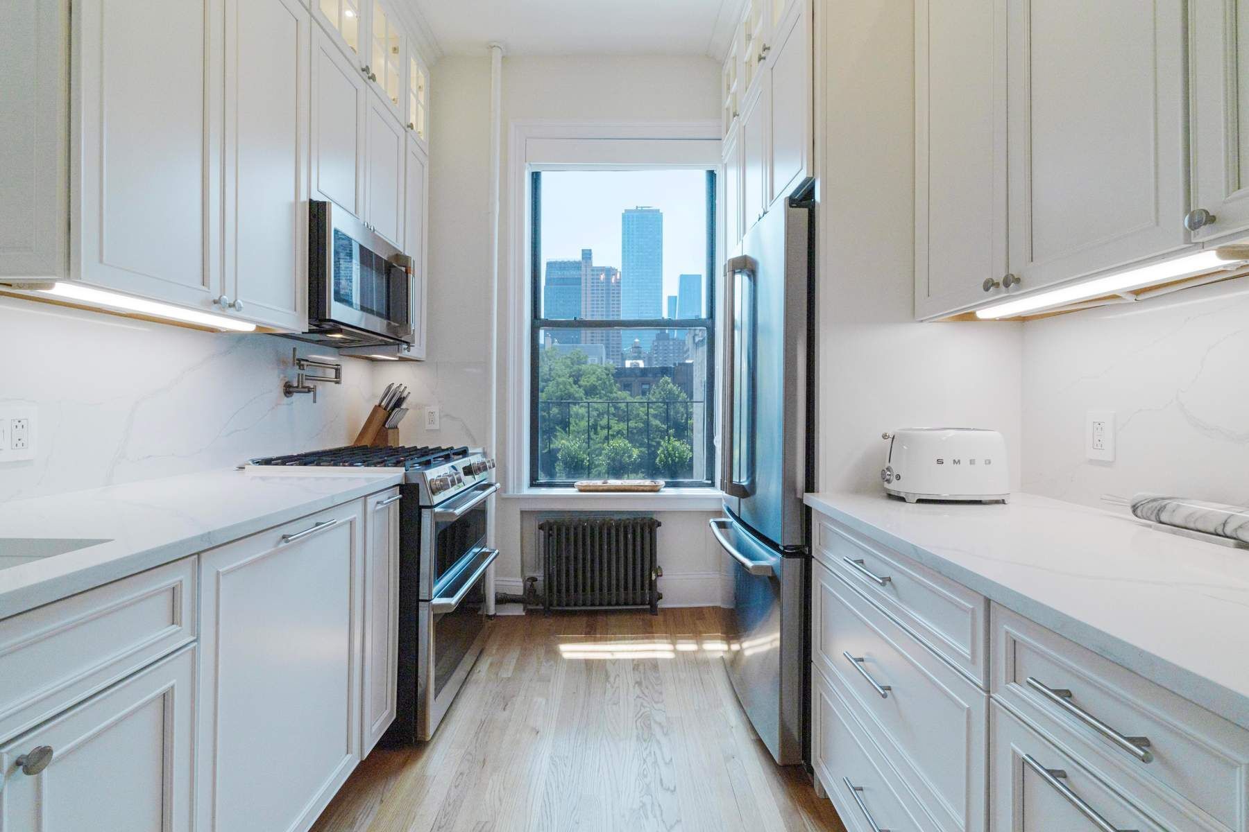 350 West 48th Street, Unit 4E Manhattan, NY 10036 - Photo 5 of 12 a kitchen with a sink cabinets and appliances