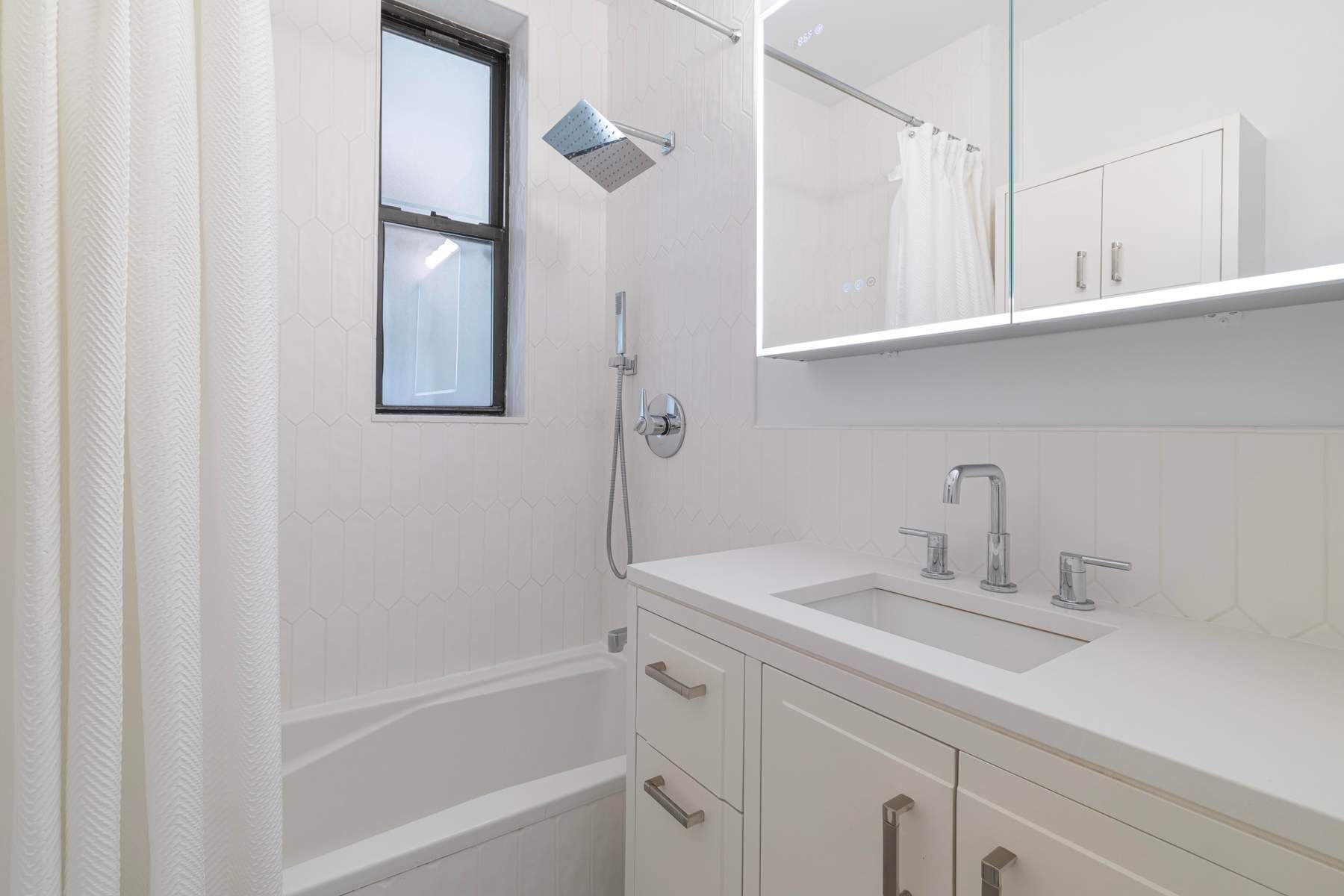 350 West 48th Street, Unit 4E Manhattan, NY 10036 - Photo 8 of 12 a bathroom with a sink and a bathtub