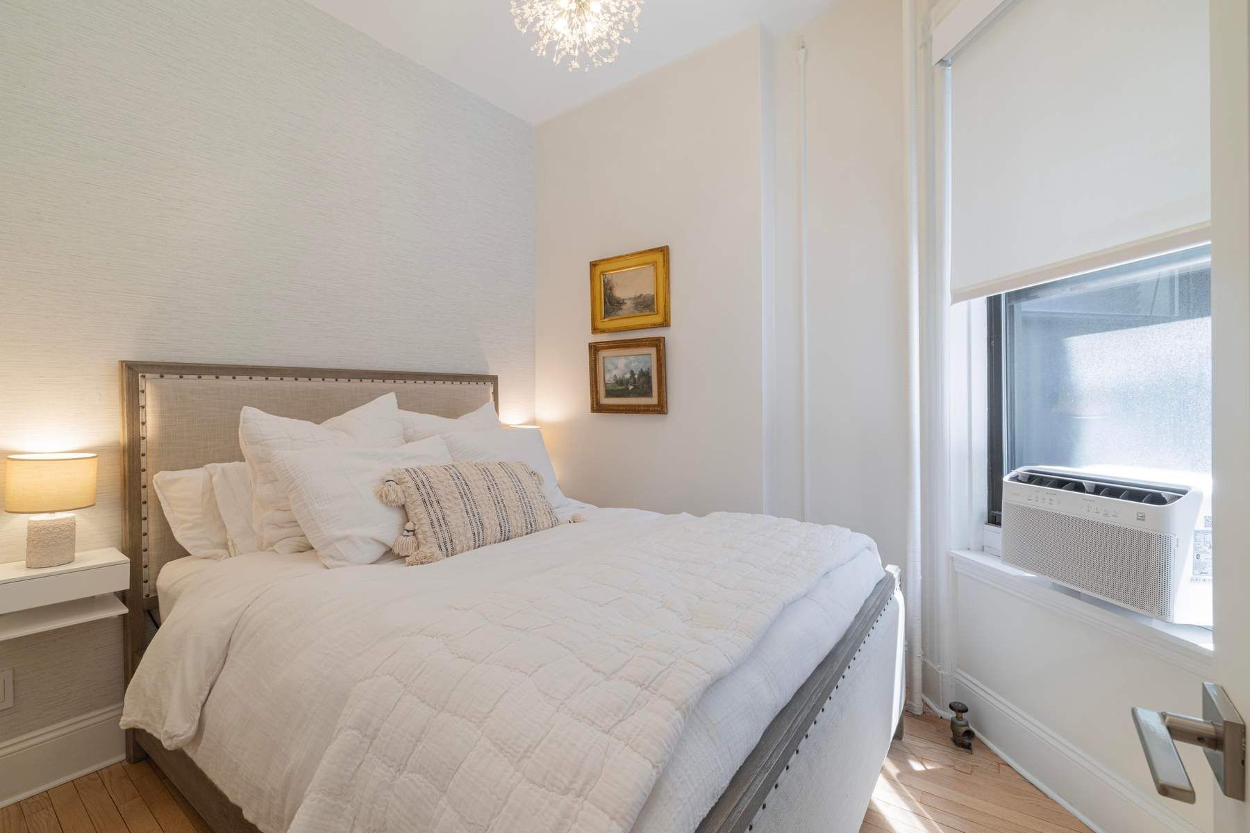 350 West 48th Street, Unit 4E Manhattan, NY 10036 - Photo 9 of 12 a bedroom with a bed and a painting on the wall