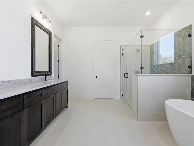 a bathroom with a double vanity sink toilet and shower