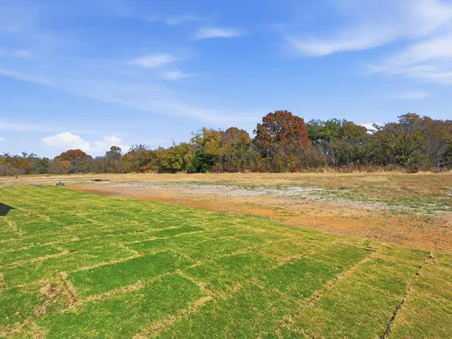 a view of a lake with houses in the background