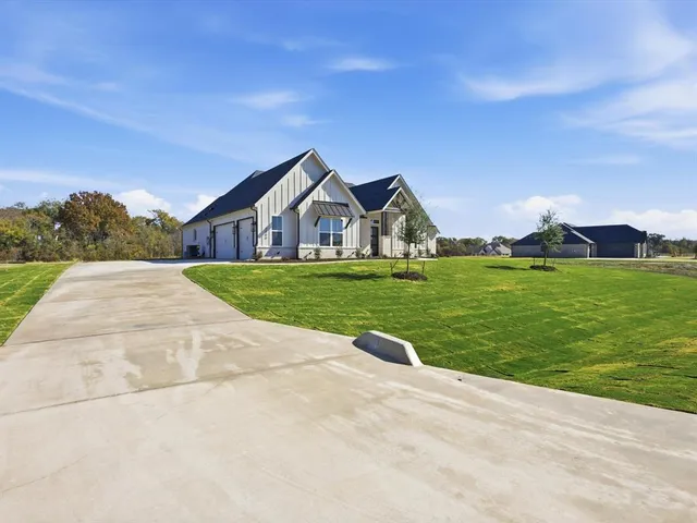 a view of a house with a yard and garage