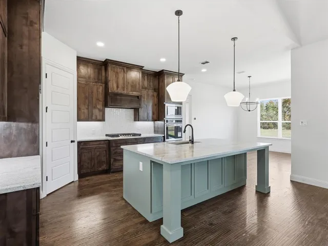 a large kitchen with kitchen island a island in the center