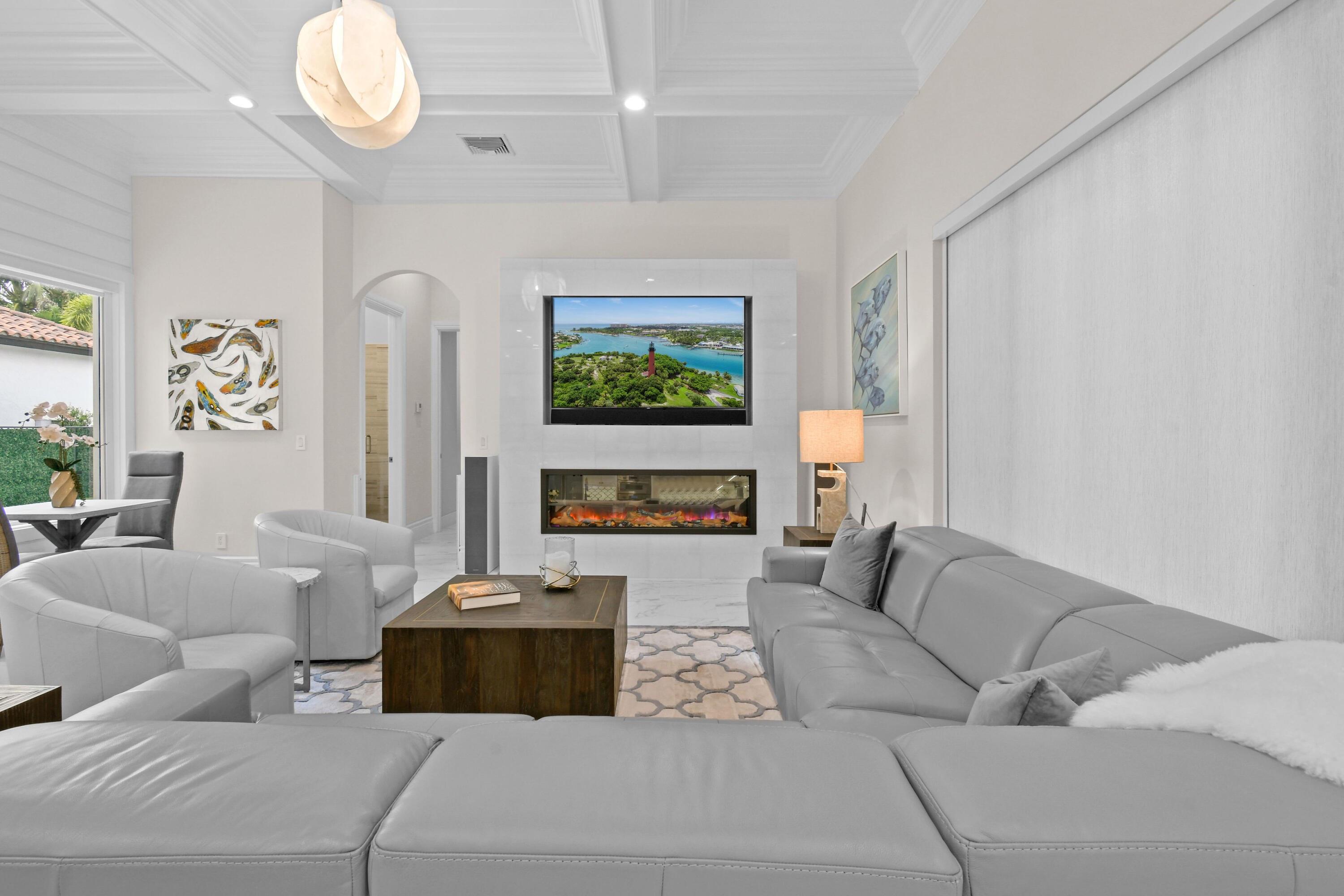 123 Barcelona Drive Jupiter, FL 33458 - Photo 14 of 59 a living room with furniture a fireplace and a large window