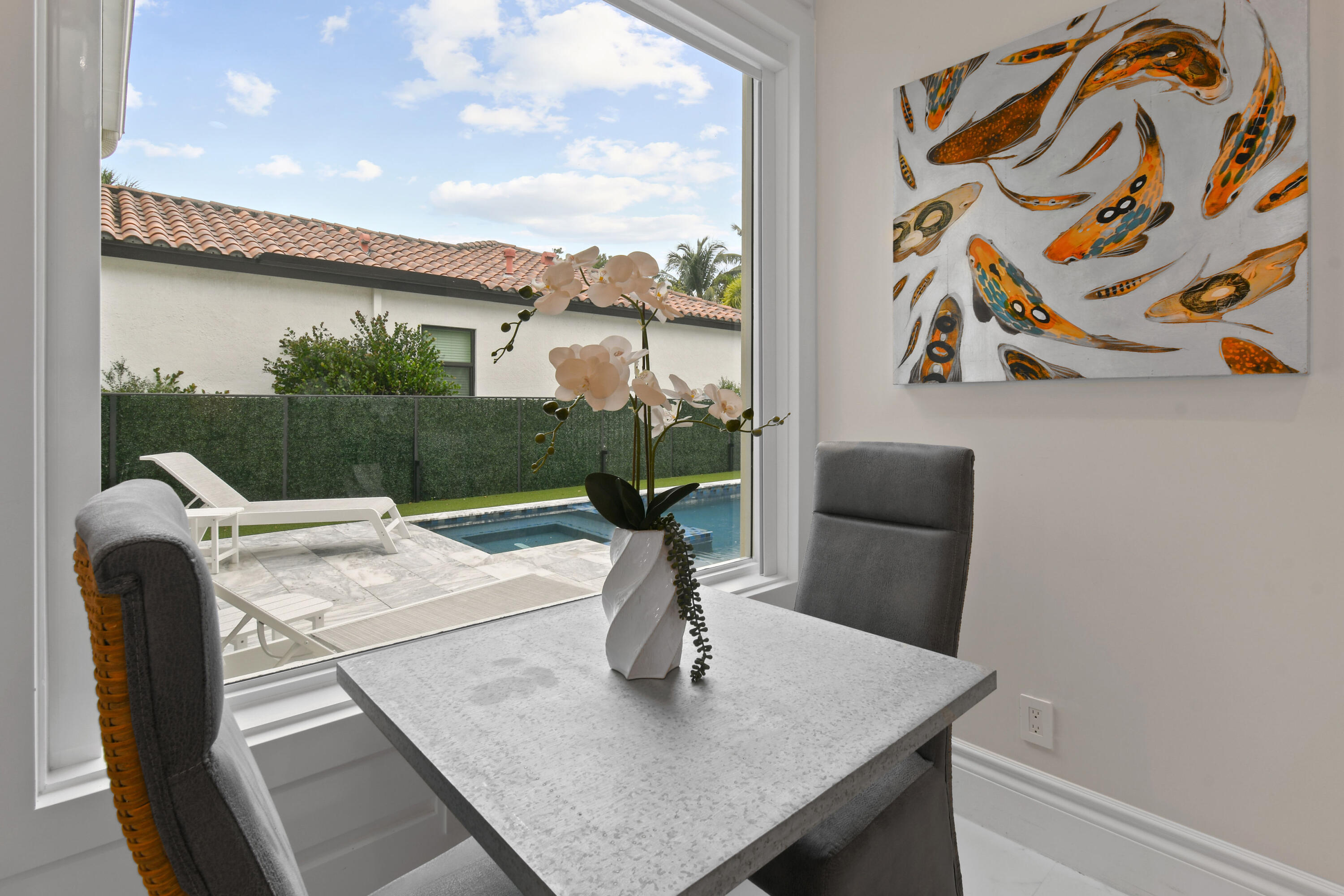 123 Barcelona Drive Jupiter, FL 33458 - Photo 16 of 59 a view of a dining room with a table and chairs