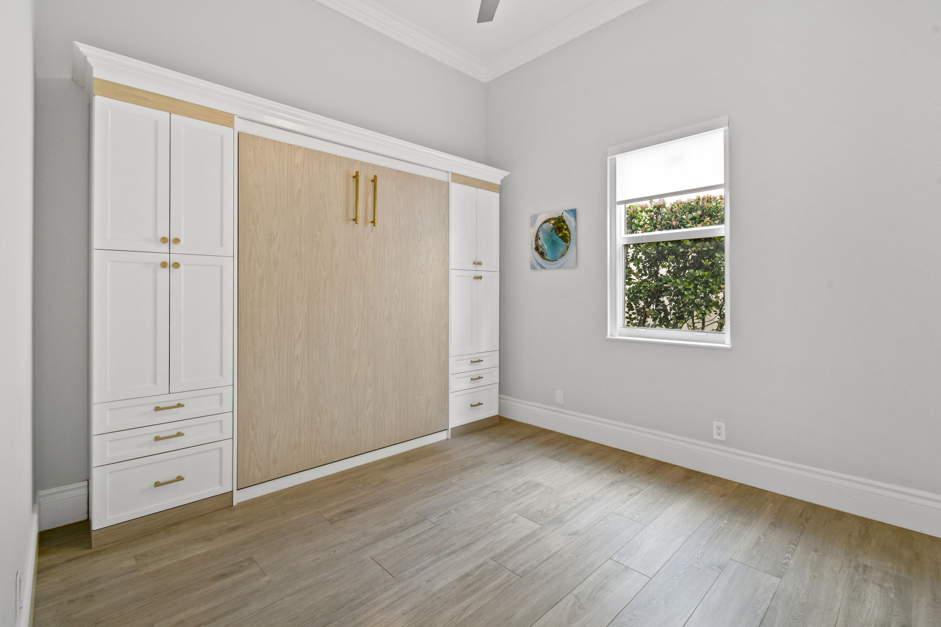 123 Barcelona Drive Jupiter, FL 33458 - Photo 24 of 59 an empty room with wooden floor and window