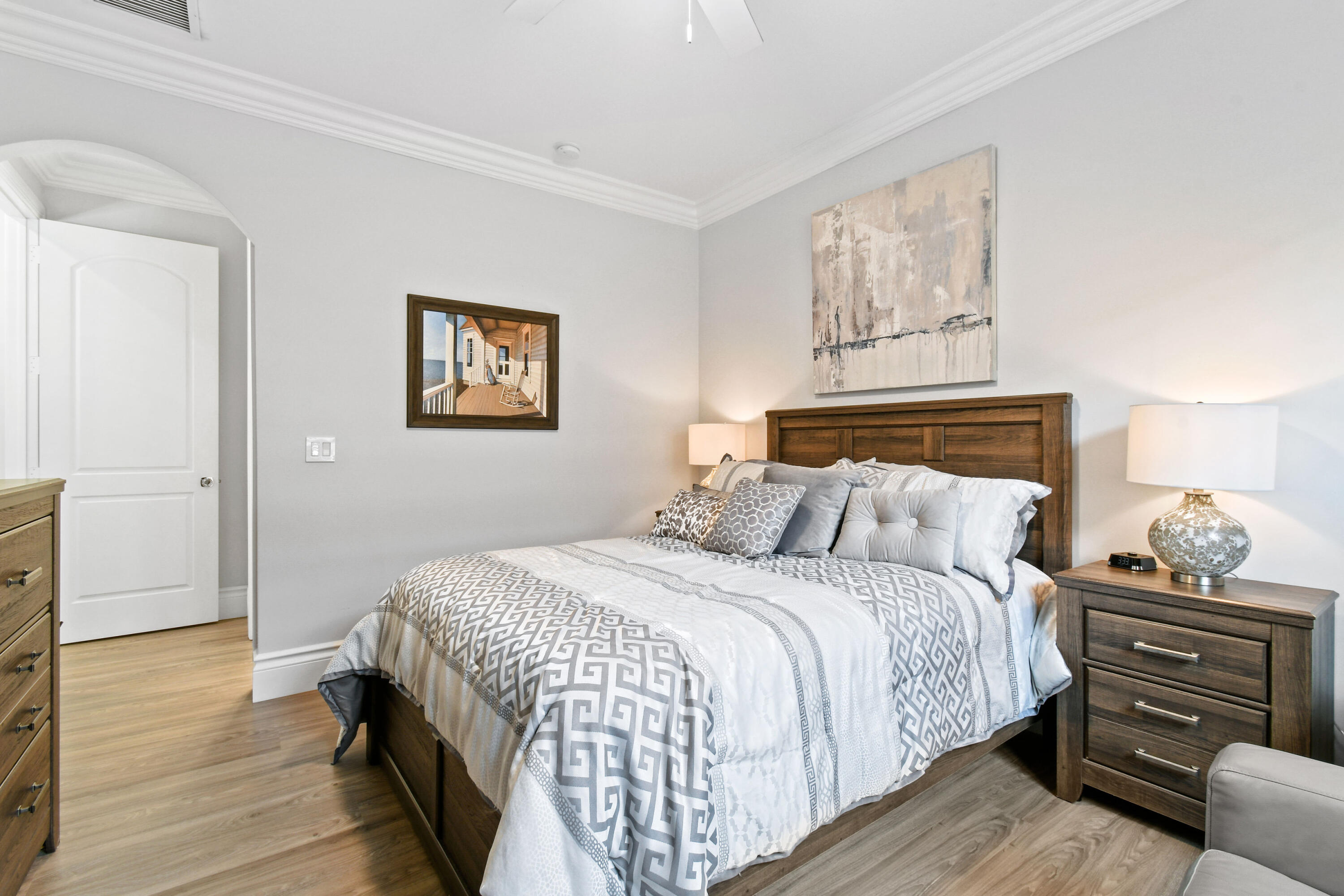 123 Barcelona Drive Jupiter, FL 33458 - Photo 29 of 59 a bedroom with a bed and wooden floor