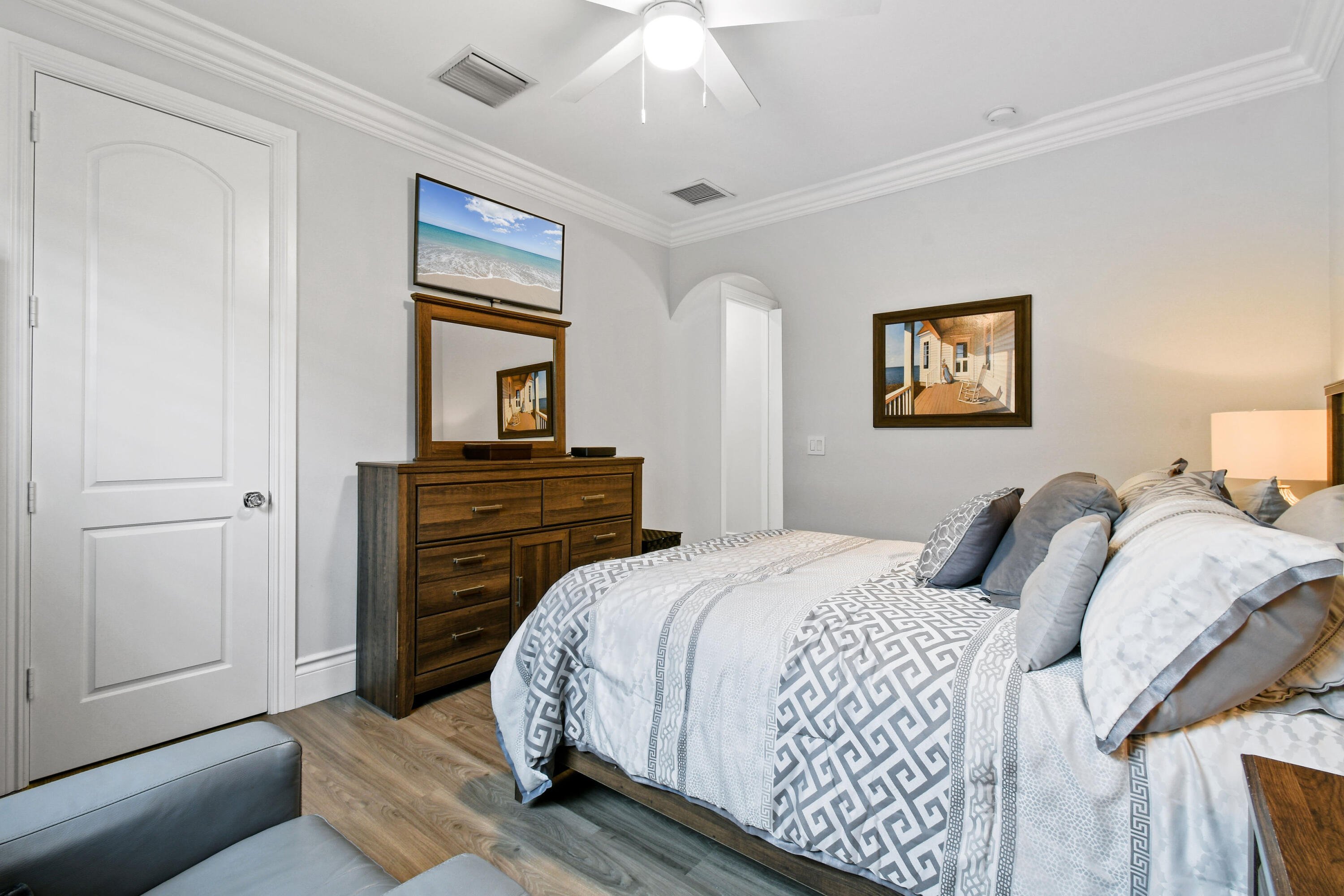 123 Barcelona Drive Jupiter, FL 33458 - Photo 30 of 59 a bedroom with a bed and a lamp on dresser