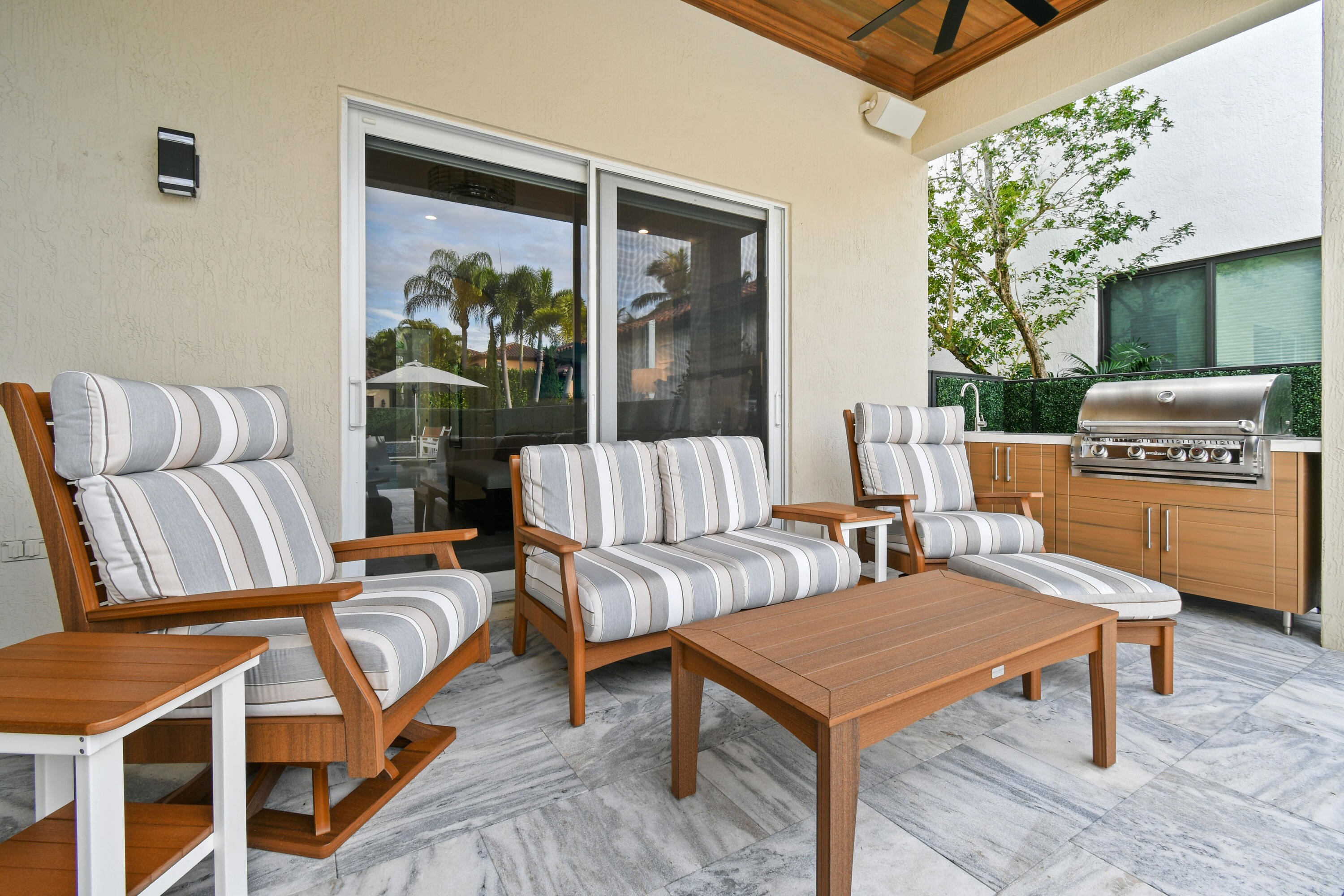 123 Barcelona Drive Jupiter, FL 33458 - Photo 37 of 59 a living room with furniture and a floor to ceiling window
