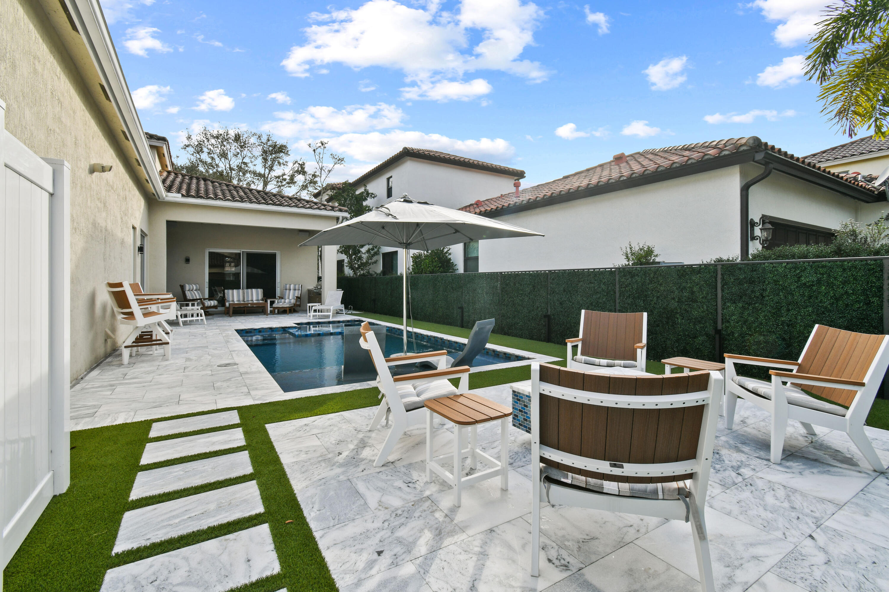 123 Barcelona Drive Jupiter, FL 33458 - Photo 41 of 59 a view of a patio with couches table and chairs