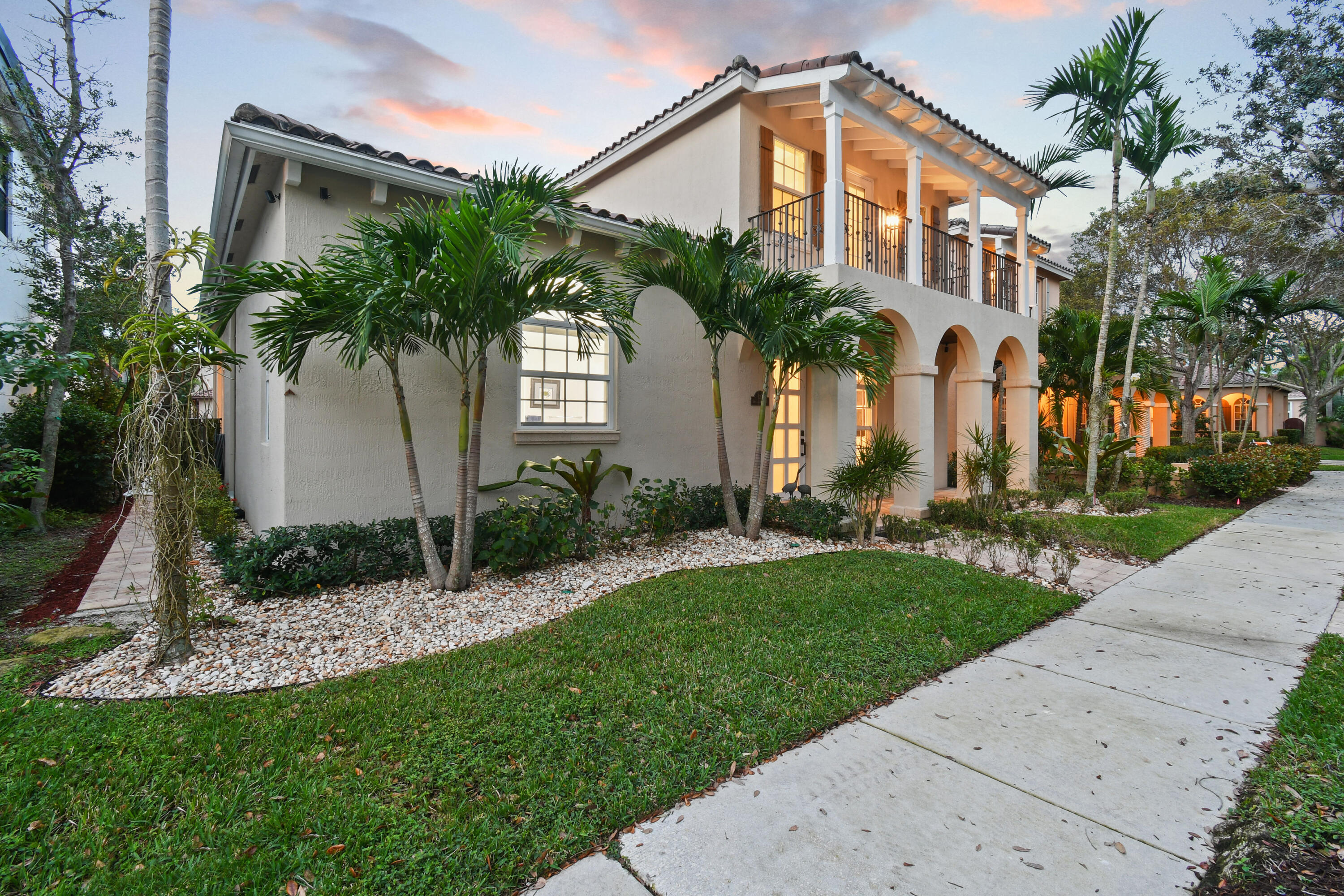 123 Barcelona Drive Jupiter, FL 33458 - Photo 54 of 59 a front view of a house with a yard and potted plants
