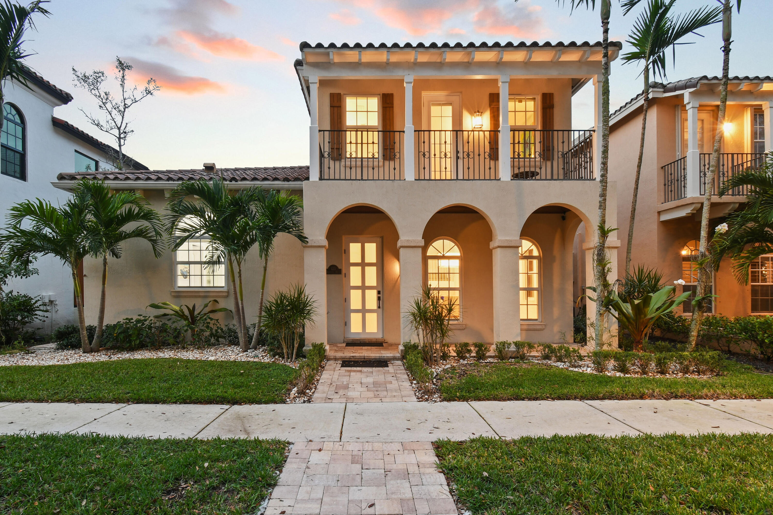 123 Barcelona Drive Jupiter, FL 33458 - Photo 55 of 59 a front view of multiple houses with yard