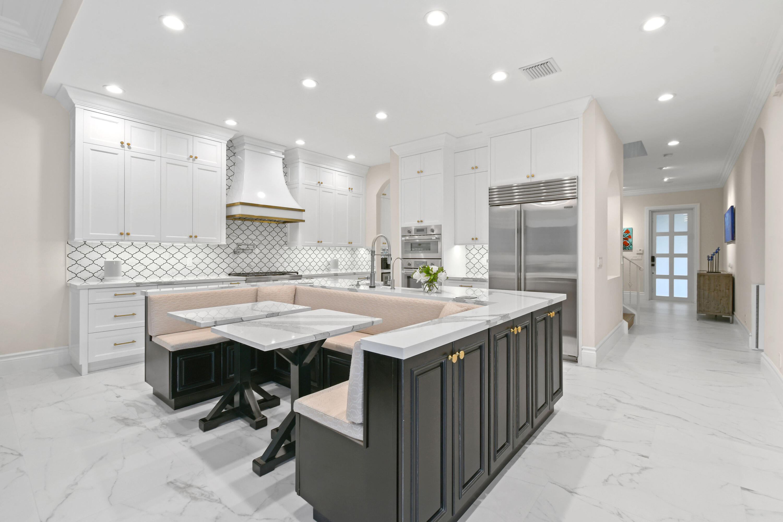 123 Barcelona Drive Jupiter, FL 33458 - Photo 7 of 59 a kitchen with kitchen island granite countertop a sink and a refrigerator