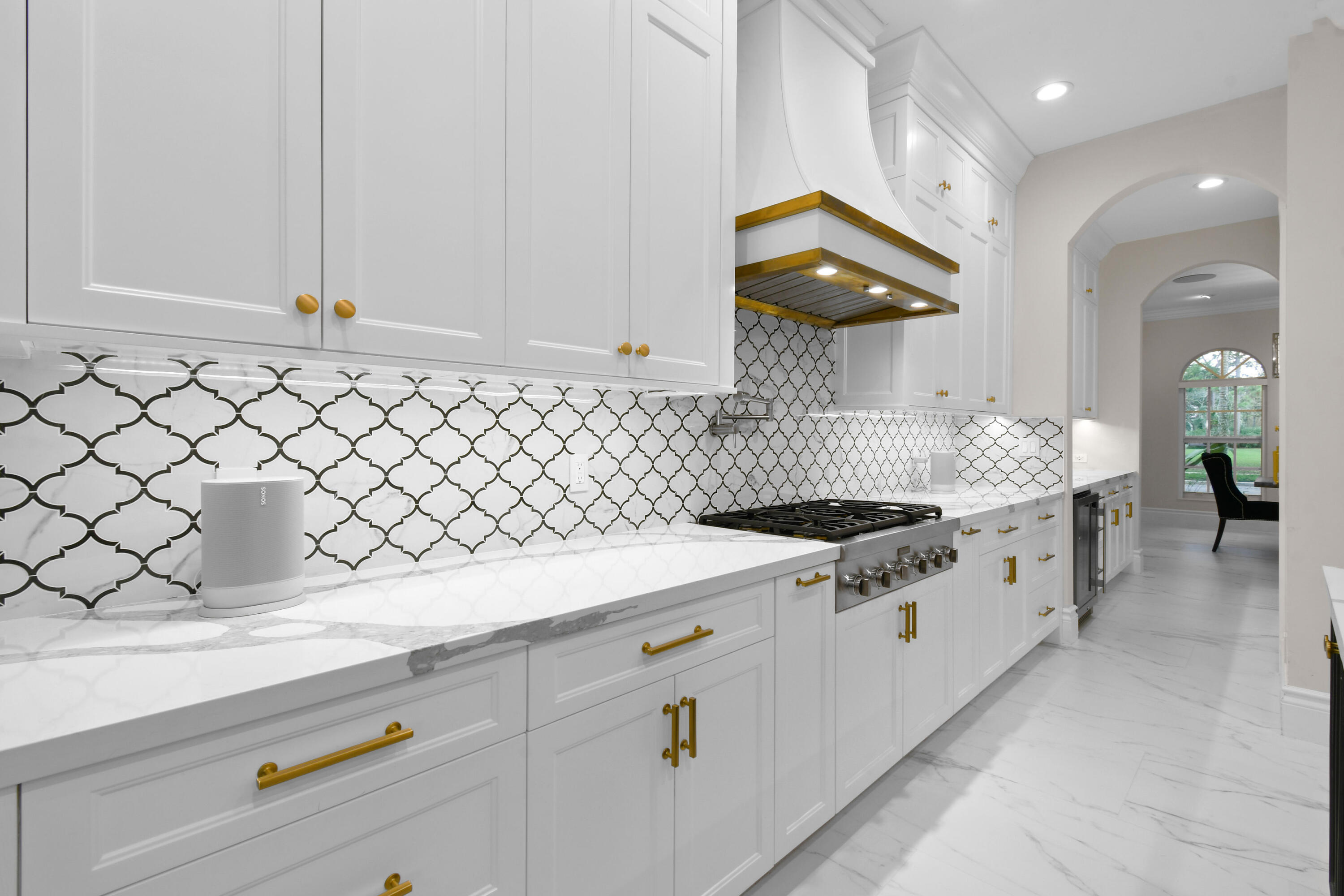 123 Barcelona Drive Jupiter, FL 33458 - Photo 9 of 59 a kitchen with granite countertop white cabinets and white appliances