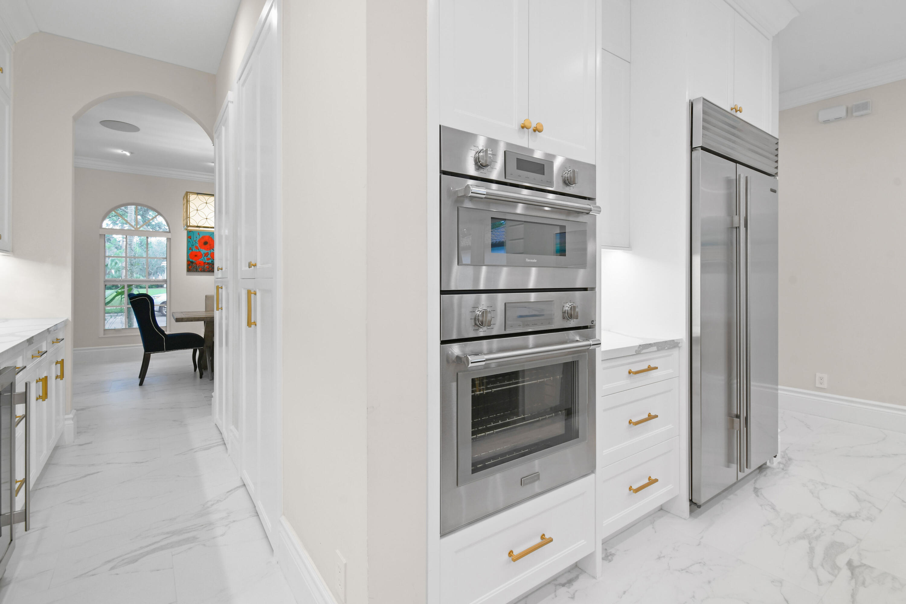 123 Barcelona Drive Jupiter, FL 33458 - Photo 10 of 59 a kitchen with cabinets and stainless steel appliances