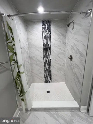 a bathroom with a bathtub and shower