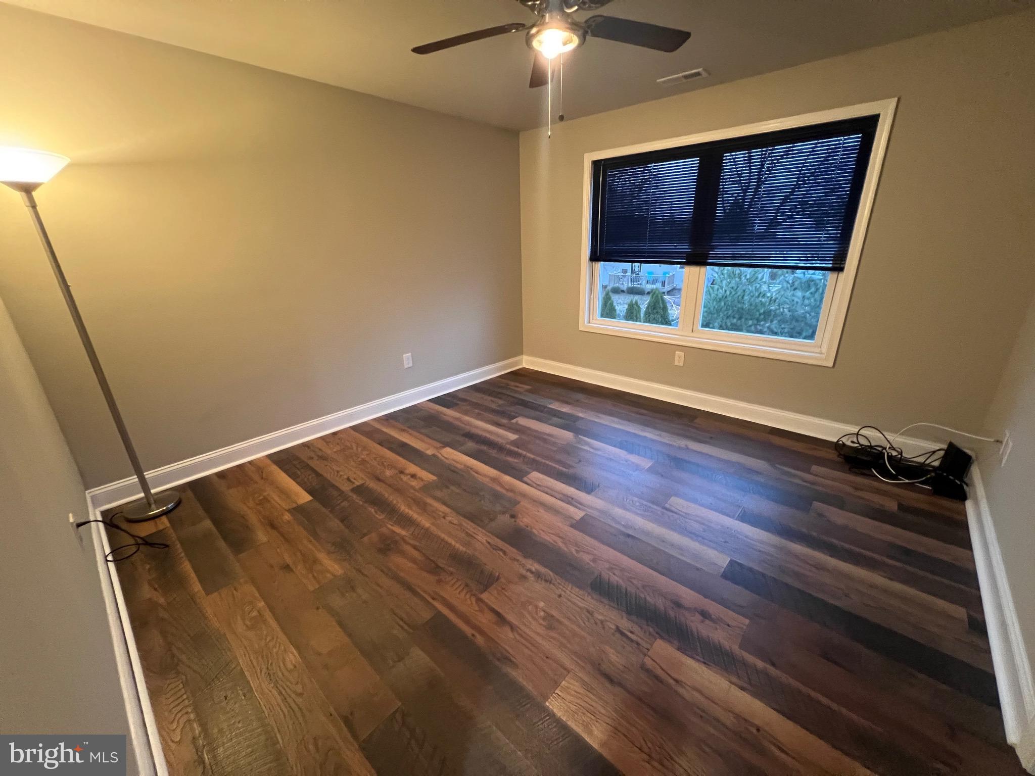 1206 Sycamore Avenue Croydon, PA 19021 - Photo 21 of 24 a view of an empty room with a window and wooden floor