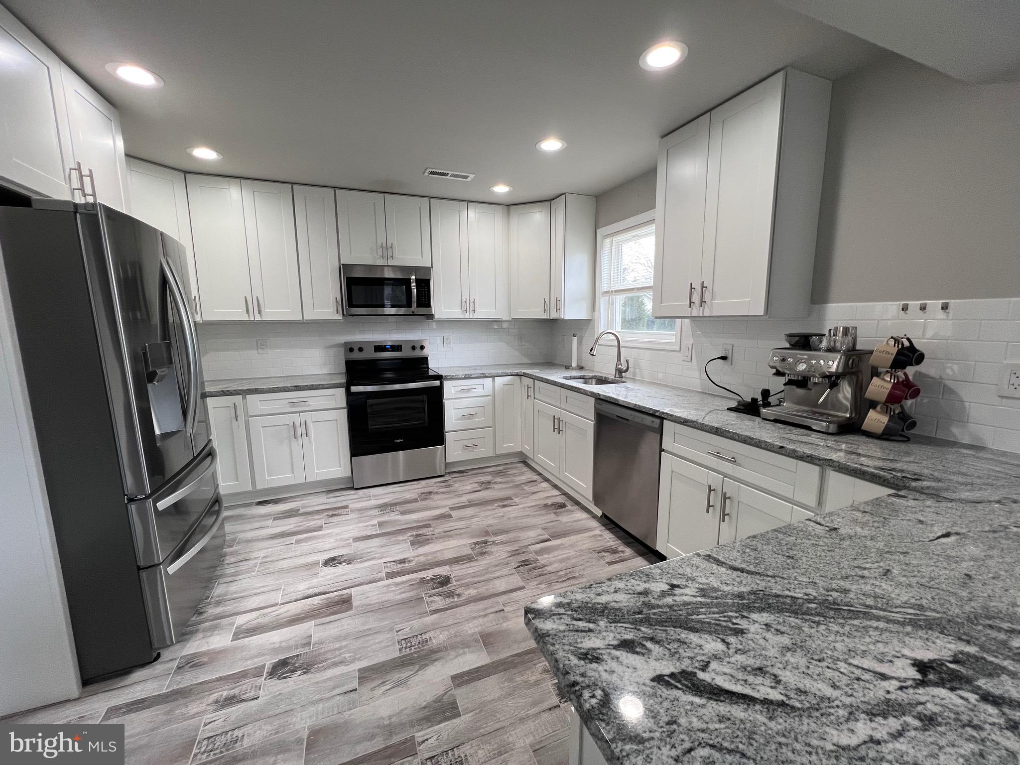 1206 Sycamore Avenue Croydon, PA 19021 - Photo 7 of 24 a kitchen with stainless steel appliances granite countertop a refrigerator sink and cabinets