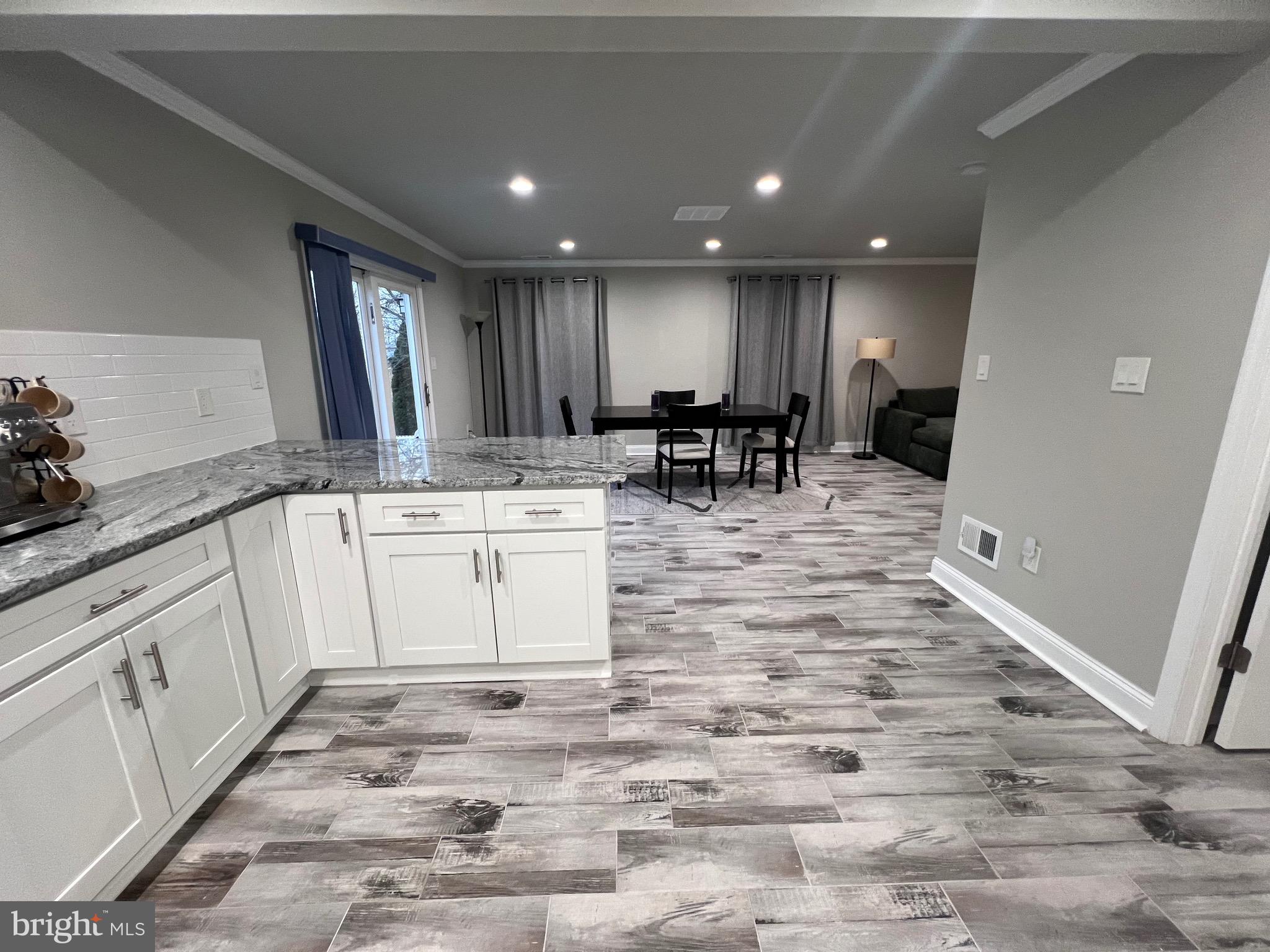 1206 Sycamore Avenue Croydon, PA 19021 - Photo 9 of 24 a view of a kitchen with granite countertop a sink and white cabinets