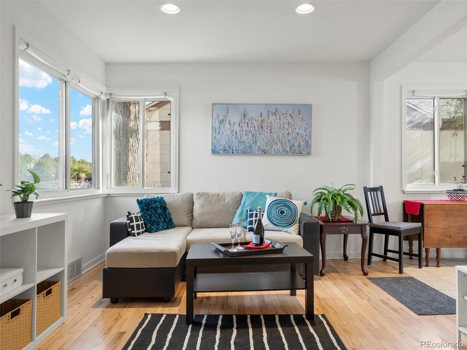 2865 Quebec Street Denver, CO 80207 - Photo 1 of 30 a living room with furniture and a rug