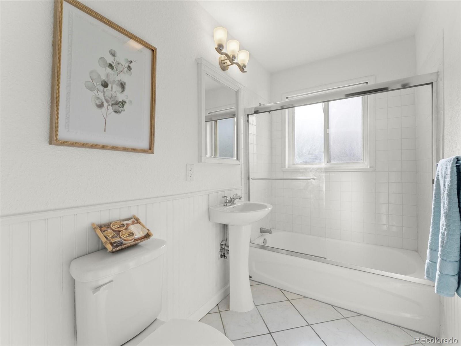 2865 Quebec Street Denver, CO 80207 - Photo 15 of 30 a bathroom with a shower and a bathtub