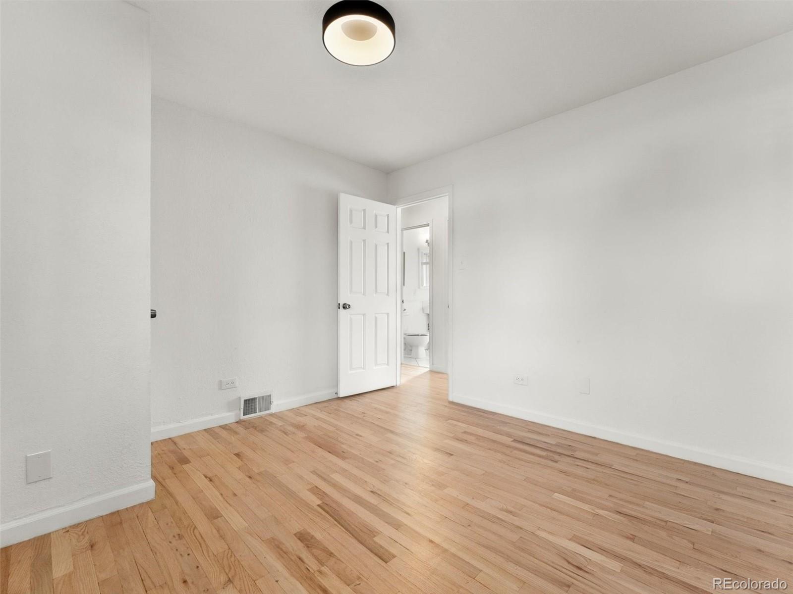 2865 Quebec Street Denver, CO 80207 - Photo 20 of 30 a view of empty room with wooden floor