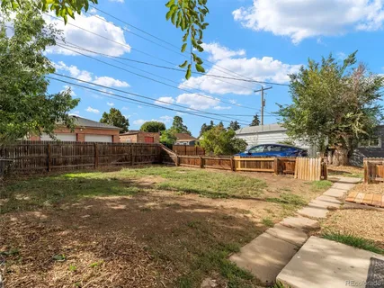 a view of backyard of house with green space