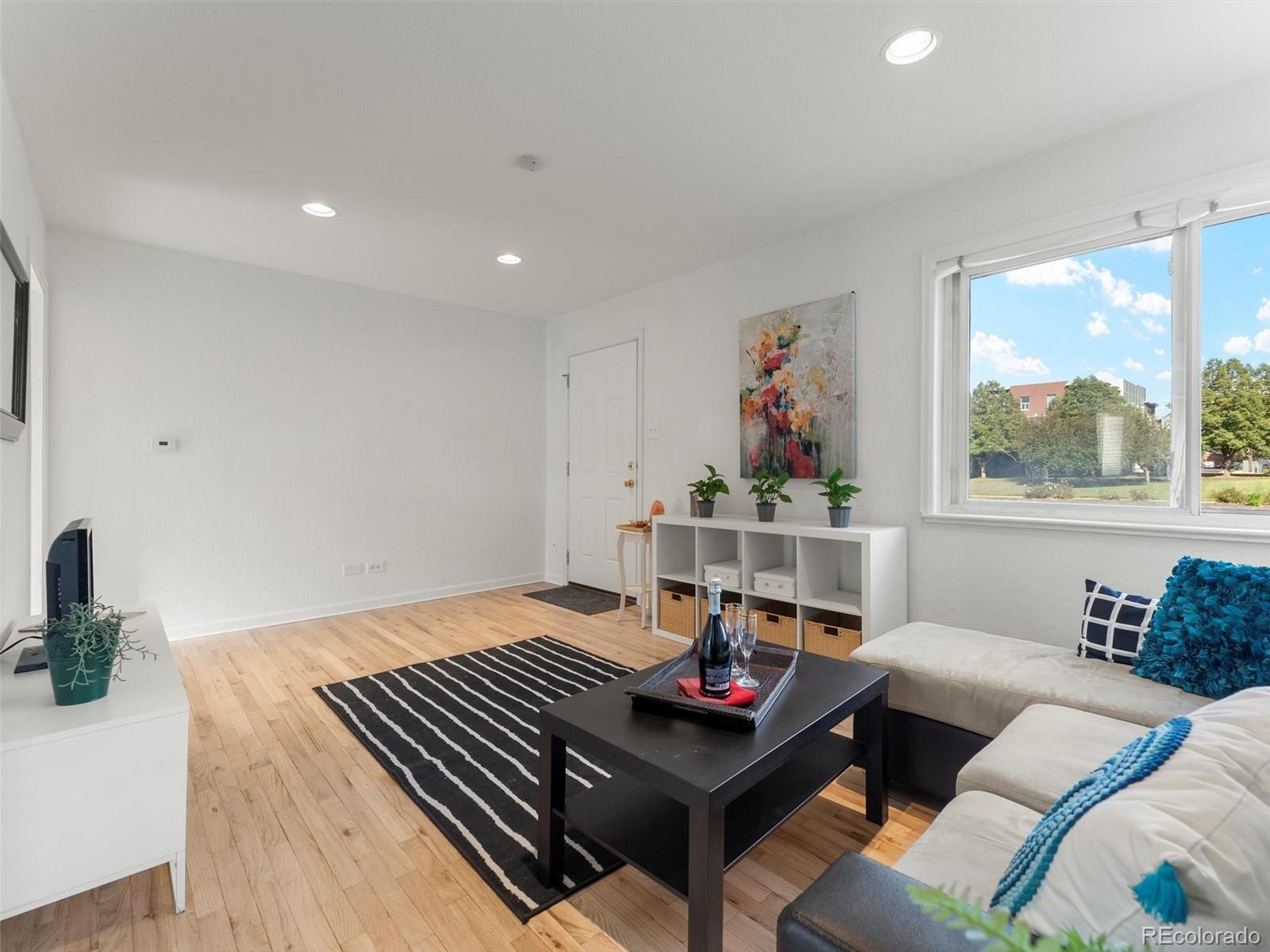 2865 Quebec Street Denver, CO 80207 - Photo 7 of 30 a living room with furniture and a window