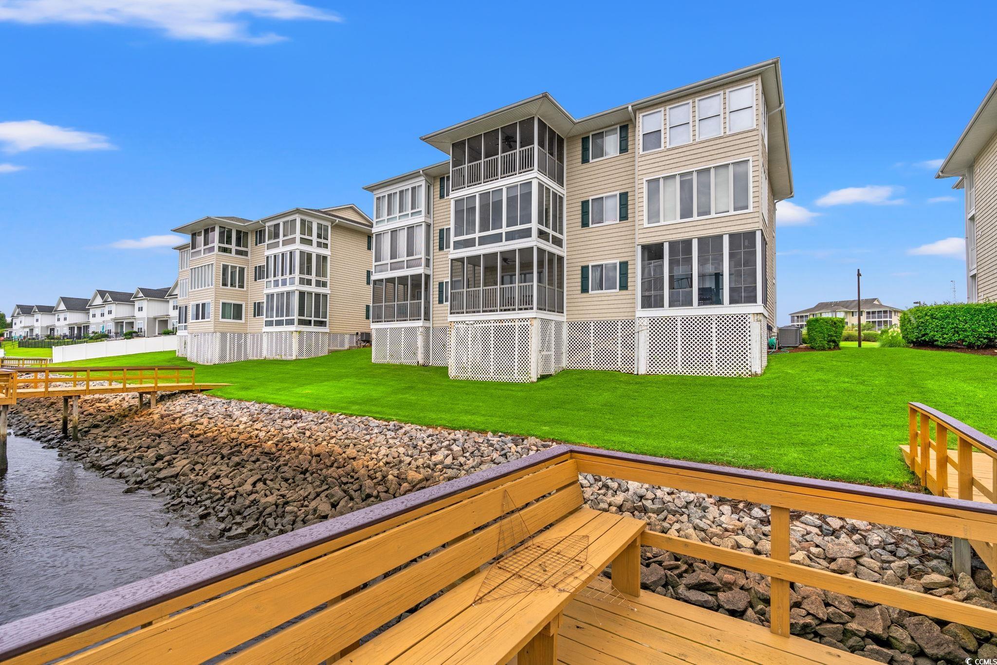 216 Landing Road, Unit H216 North Myrtle Beach, SC 29582 - Photo 22 of 23 Dock with a water view and a lawn