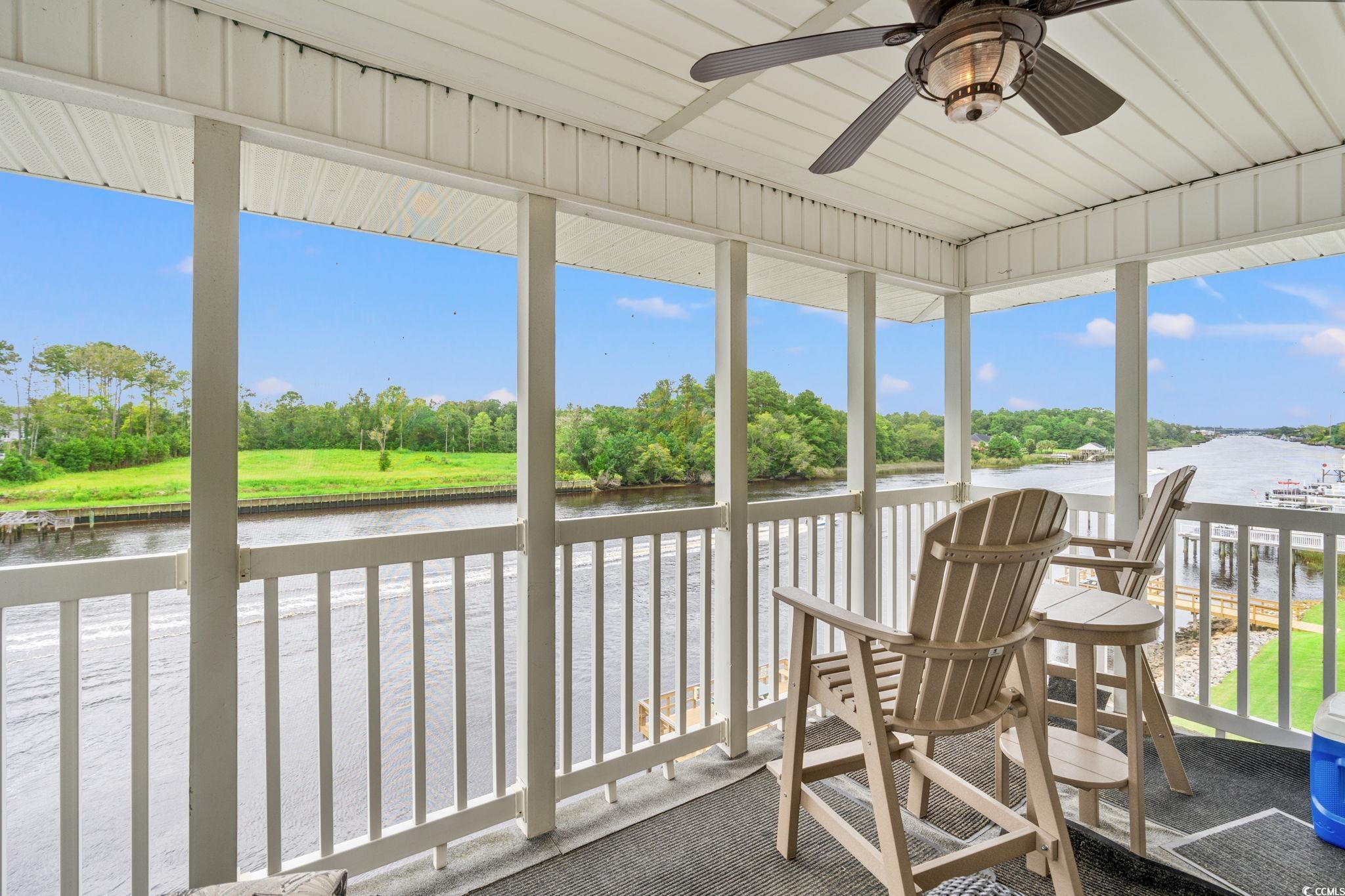216 Landing Road, Unit H216 North Myrtle Beach, SC 29582 - Photo 4 of 23 Sunroom with a water view and a ceiling fan