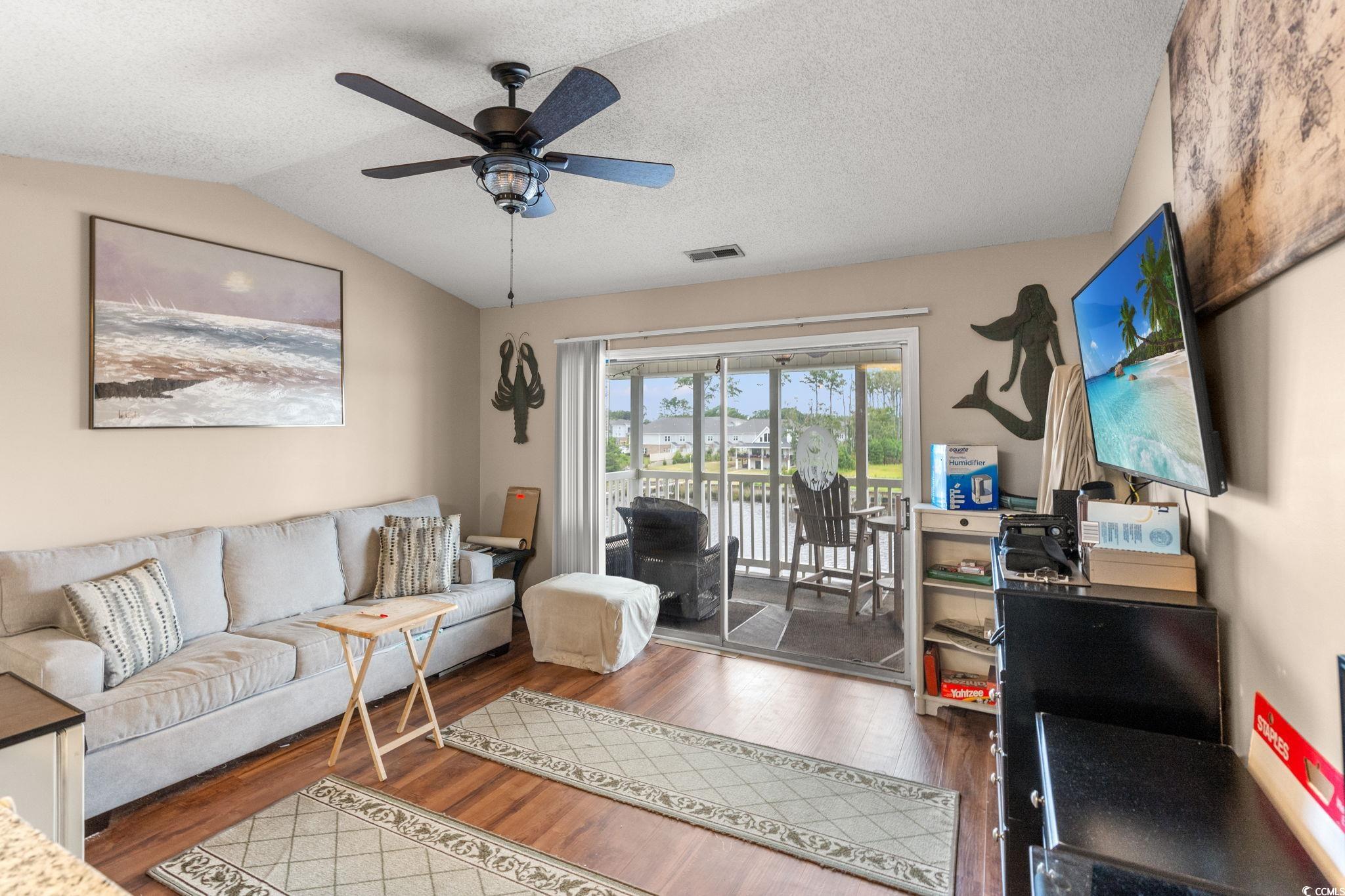 216 Landing Road, Unit H216 North Myrtle Beach, SC 29582 - Photo 5 of 23 Sunroom with a water view, view of wooded area, and a ceiling fan