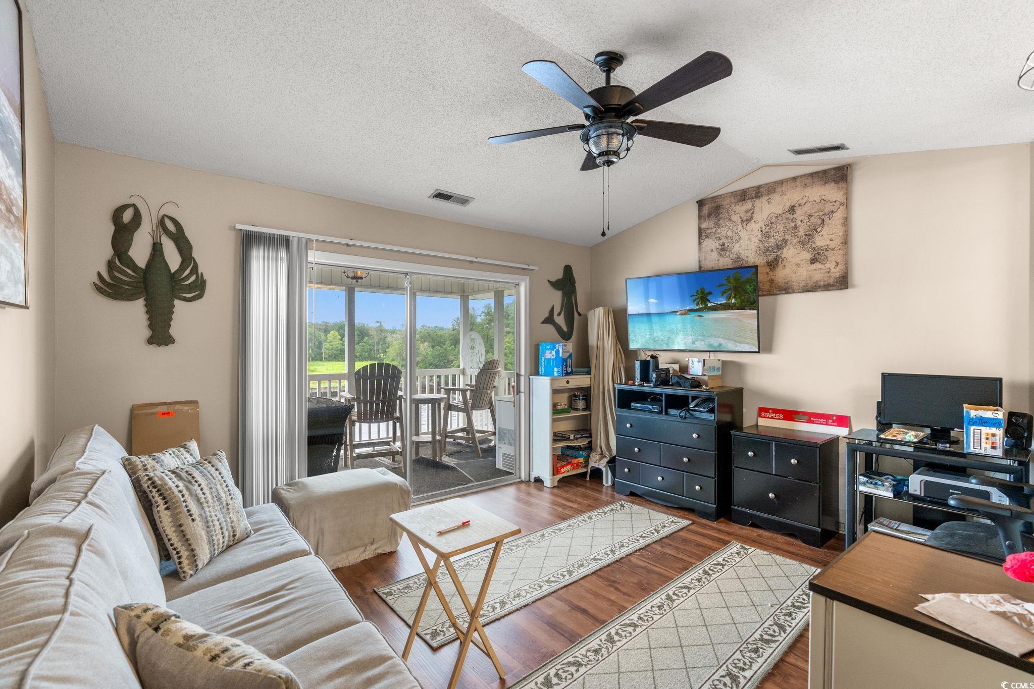 216 Landing Road, Unit H216 North Myrtle Beach, SC 29582 - Photo 7 of 23 Living room featuring dark wood-style floors, a textured ceiling, lofted ceiling, and ceiling fan