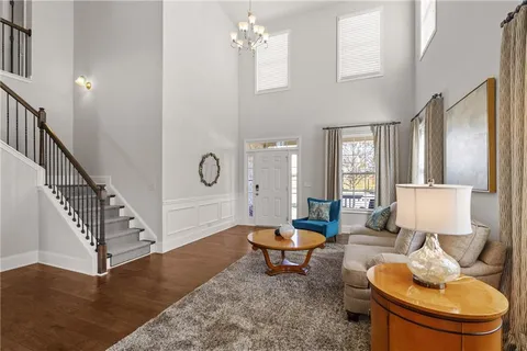a living room with furniture a table and wooden floor