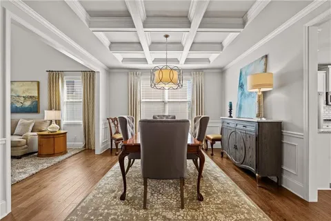 a living room with furniture a chandelier and a dining room