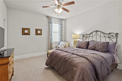 a bathroom with a granite countertop toilet a sink and a mirror