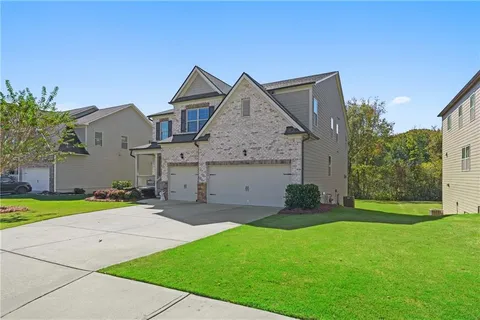 an aerial view of a house with a yard basket ball court and outdoor seating