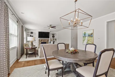 a view of a dining room with furniture window and wooden floor