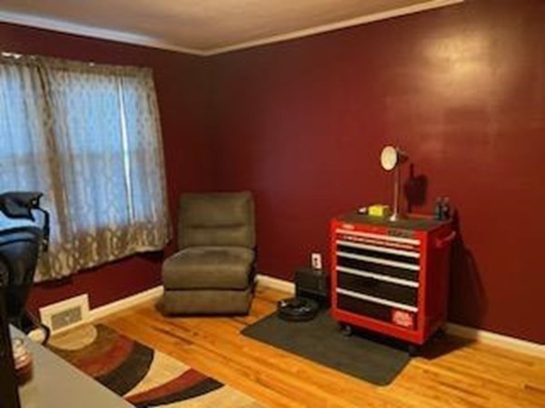 33 Kittrell Street Springfield, MA 01119 - Photo 13 of 23 a bedroom with a bed and a chair