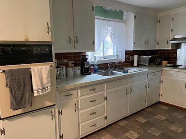 33 Kittrell Street Springfield, MA 01119 - Photo 5 of 23 a kitchen with stainless steel appliances granite countertop a sink a stove and white cabinets