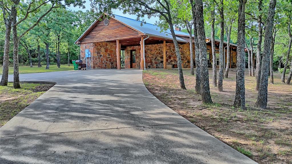 4509 Lazy E Road St. Jo, TX 76265 - Photo 16 of 39 a view of a house with backyard and trees