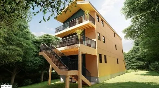 a view of a house with backyard and sitting area
