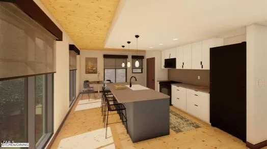 a room with kitchen island a sink a counter top space and stainless steel appliances