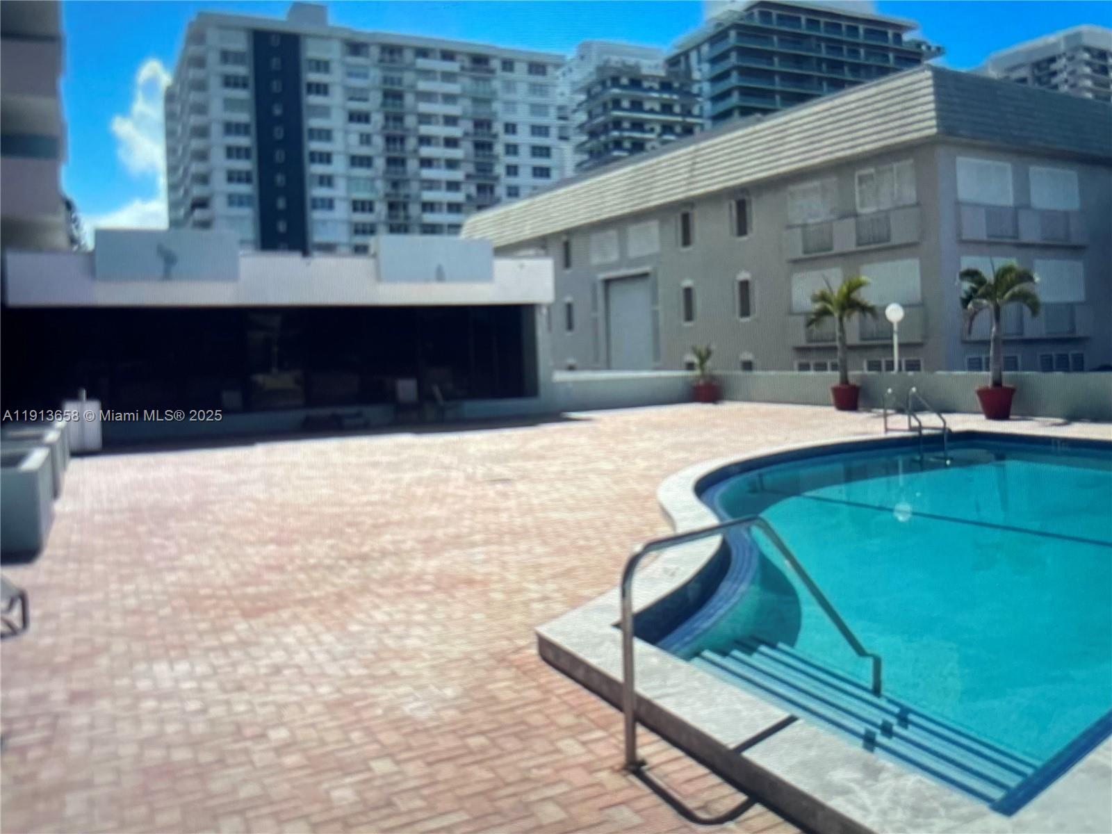 5838 Collins Avenue, Unit PHF Miami Beach, FL 33140 - Photo 13 of 16 a swimming pool with outdoor seating