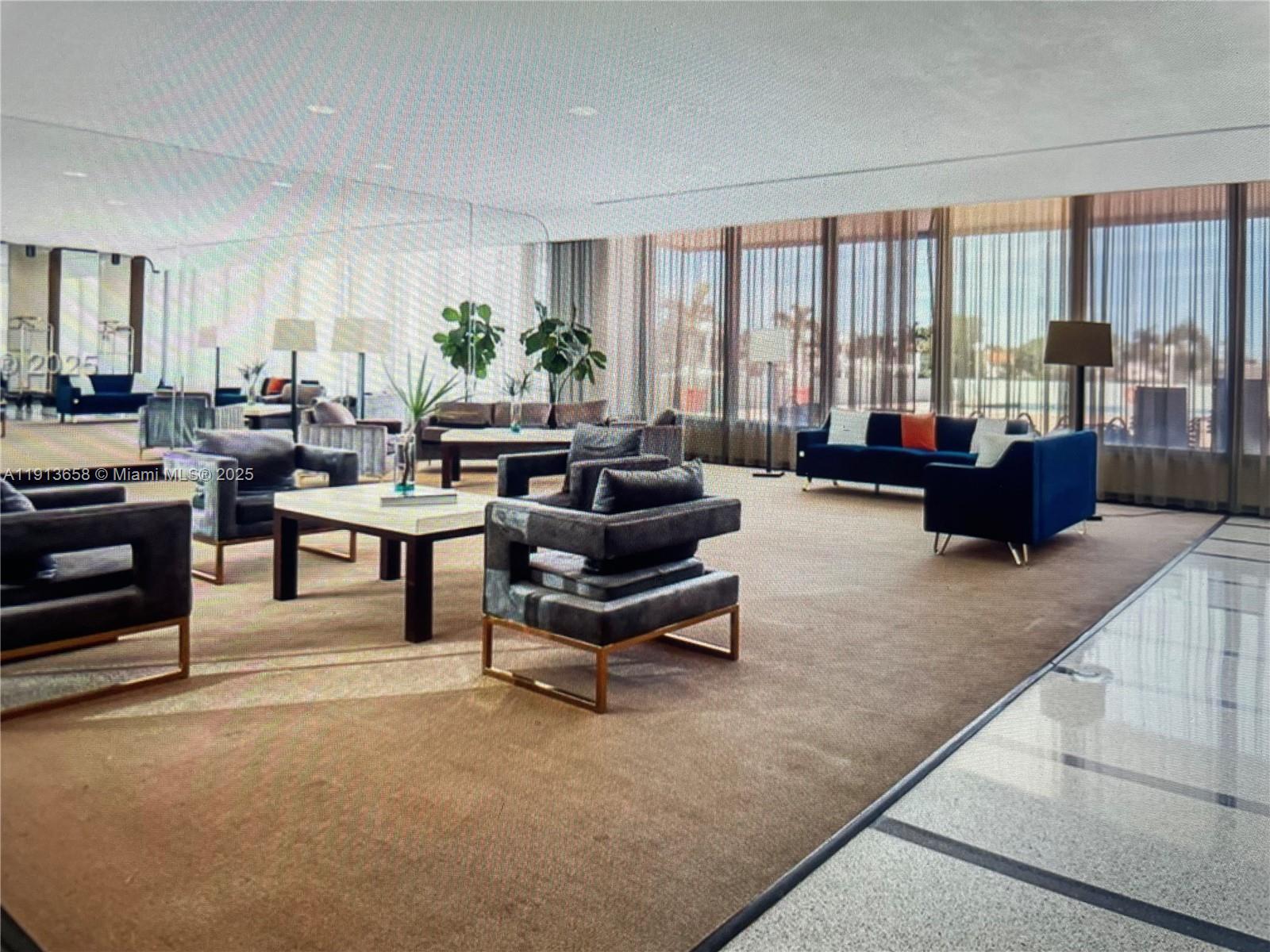 5838 Collins Avenue, Unit PHF Miami Beach, FL 33140 - Photo 15 of 16 a living room with furniture and a large window